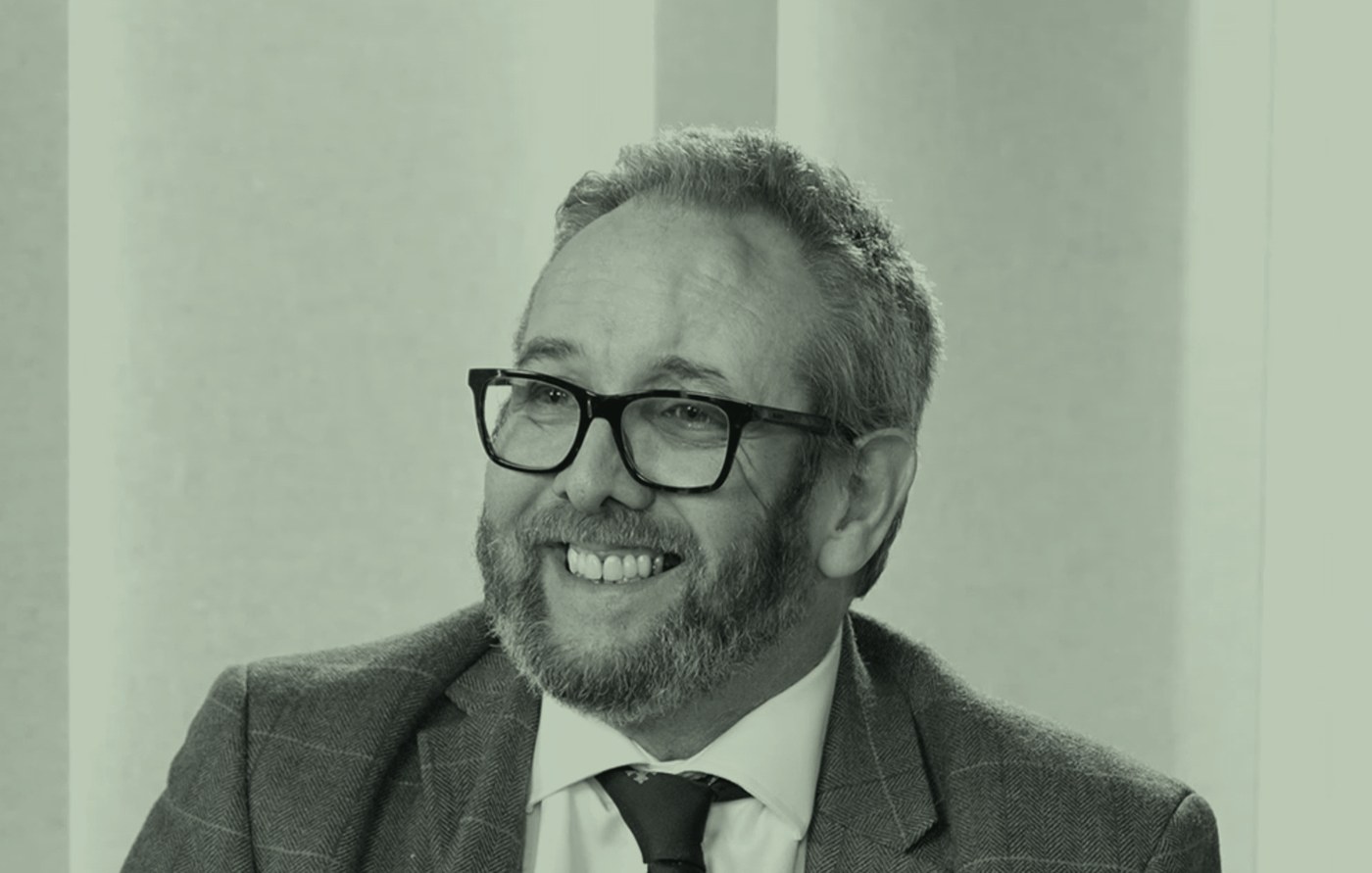 Al Kingsley laughing in conversation in a podcast studio