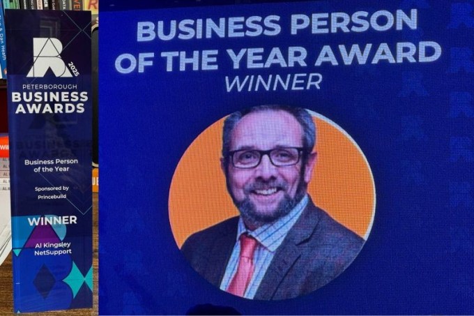 Business Person of the Year winner screen at the Peterborough Business Awards, with the award on the shelf beside it