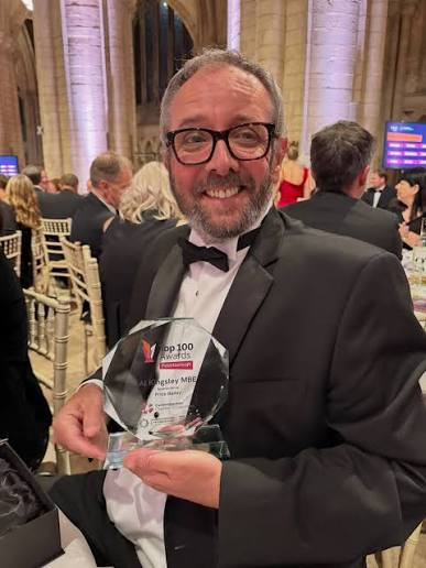 Al Kingsley holding the Peterborough Top 100 award at the ceremony